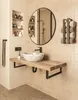 A modern bathroom vanity with a wooden countertop, marble sink, and black fixtures. Produktbild-Vorschau