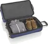 An open blue suitcase with a gray jacket and two brown shoes inside, placed on a white background. Produktbild-Vorschau