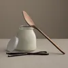 A glass jar of yogurt with a spoon and vanilla beans. Produktbild-Vorschau