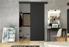A modern interior scene featuring a black sliding door, a desk with a laptop, and decorative items. Náhled obrázku produktu