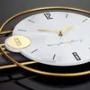 Close-up of a modern wall clock with a marble-effect face and gold accents. Produktbild-Vorschau