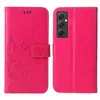 A pink flip phone case with a floral and butterfly design is shown open, revealing the inside and the phone it protects. The phone is visible on the right side of the image. Produktbild-Vorschau