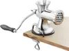 A manual meat grinder clamped to a wooden surface. Podgląd zdjęcia produktu