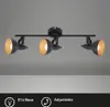 A black and gold metal track light fixture with three adjustable spotlights against a plain gray background. Voir les images du produit