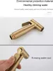 A close-up of a gold bidet sprayer, with a hand pressing the trigger in the bottom panel. Produktbild-Vorschau