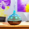 An aroma diffuser with LED lighting sits on a wooden table, with abstract art in the background. Produktbild-Vorschau