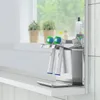 A toothbrush head holder on a shelf in front of a window. Anteprima dell’immagine prodotto