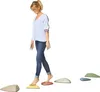 A woman is walking on a set of stepping stones. Anteprima dell’immagine prodotto