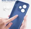 A hand is touching a blue phone case, highlighting its matte surface and soft grip. Produktbild-Vorschau