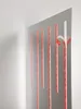 A close-up of red adhesive strips on a silver surface. Podgląd zdjęcia produktu