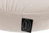 A close-up of a cream-colored fabric with a black tag attached. Náhled obrázku produktu