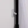 A close-up shot of a black pole with a white clip attached to it, holding up a sheer white fabric. The pole is mounted on a white wall. Anteprima dell’immagine prodotto