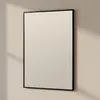 A rectangular mirror with a black frame hangs on a light-colored wall, with shadows cast on the wall. Anteprima dell’immagine prodotto