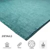 Close-up of a teal rug with marketing icons and text. Produktbild-Vorschau