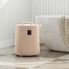A beige towel warmer sits next to a white bathtub in a bathroom. Anteprima dell’immagine prodotto