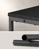 Close-up of a black table leg and support structure, with a detail showing a hollow metal tube. Náhled obrázku produktu