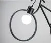 A close-up shot of a black bicycle-shaped pendant light with a white light bulb. Podgląd zdjęcia produktu