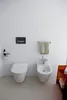 A clean, modern bathroom with a toilet and bidet. Produktbild-Vorschau