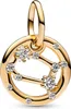 A close-up studio shot of a gold-colored zodiac charm with clear stones. Podgląd zdjęcia produktu
