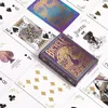 A flat lay of Bicycle playing cards, featuring a purple and gold peacock design on the box and some of the cards. Produktbild-Vorschau