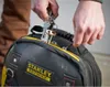 A person is holding keys above a tool bag. Voir les images du produit