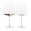 Two wine glasses on a white background. One glass contains red and white wine, the other is empty. Náhled obrázku produktu