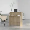 A reception desk in a modern office setting with a chair and a plant. Anteprima dell’immagine prodotto