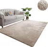 A beige rug is shown in front of a light-colored sofa with a potted plant to the side. A close-up of the rug texture is shown in a circular inset. Podgląd zdjęcia produktu
