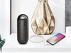 A black Philips speaker is shown next to a golden vase and a smartphone being charged. Produktbild-Vorschau