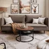 A living room scene with a sofa, coffee table, and rug. Produktbild-Vorschau
