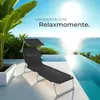 A black lounge chair with a canopy is placed on a patio next to an infinity pool overlooking the ocean. Náhled obrázku produktu
