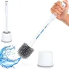 A toilet brush and holder set is shown, with a hand holding the brush and water splashing. Podgląd zdjęcia produktu