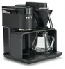 A black Melitta coffee machine with a glass carafe and a grinder. Produktbild-Vorschau
