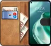 A book-style phone case is open, showing a phone screen and slots for cards and cash. Anteprima dell’immagine prodotto