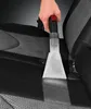 A hand is using a cleaning attachment on a car seat. Produktbild-Vorschau