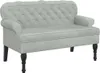 A light gray velvet sofa with tufted backrest and dark wooden legs, shown against a white background. Náhled obrázku produktu