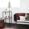 A cozy living room scene with a small Christmas tree, candles, and decorative pillows on a bench. Voir les images du produit