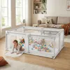 A baby playing inside a playpen filled with toys in a living room. Produktbild-Vorschau