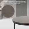 A close-up view of a round coffee table with a dark oak wood grain pattern, set against a light gray background. A larger, circular representation of the same wood pattern is visible in the midground. Produktbild-Vorschau