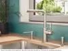 A kitchen sink area with a faucet, soap dispenser, and a drain cover. Podgląd zdjęcia produktu