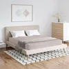 A bedroom scene with a bed, dresser, and artwork. Produktbild-Vorschau