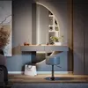 A modern vanity table with a large circular mirror and integrated lighting, a stool, and decorative items, set in a well-lit room. Anteprima dell’immagine prodotto