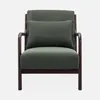A green armchair with a dark wood frame and a small lumbar pillow. Produktbild-Vorschau