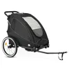 A black bicycle trailer for children, shown from a side-angle on a white background. Produktbild-Vorschau