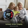 A family (mother, daughter, and grandmother) is sitting on a couch, looking at a cordless vacuum cleaner and its display screen. Produktbild-Vorschau
