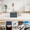 A woman sitting on a folded mattress, with smaller images below showing different uses for the mattress. Produktbild-Vorschau