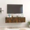 A wall-mounted TV cabinet with a television above it, and decorative items on top of the cabinet. Náhľad obrázku produktu