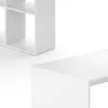 A close-up view of a white desk and a white shelving unit, both appearing to be made of composite wood. Podgląd zdjęcia produktu