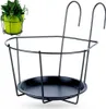 A black metal hanging planter basket with hooks, shown against a white background. A small inset image shows a green potted plant in a similar basket. Náhľad obrázku produktu