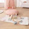 A child's play area with a tent, floor cushion, and a wooden toy toolbox with accessories. Produktbild-Vorschau
